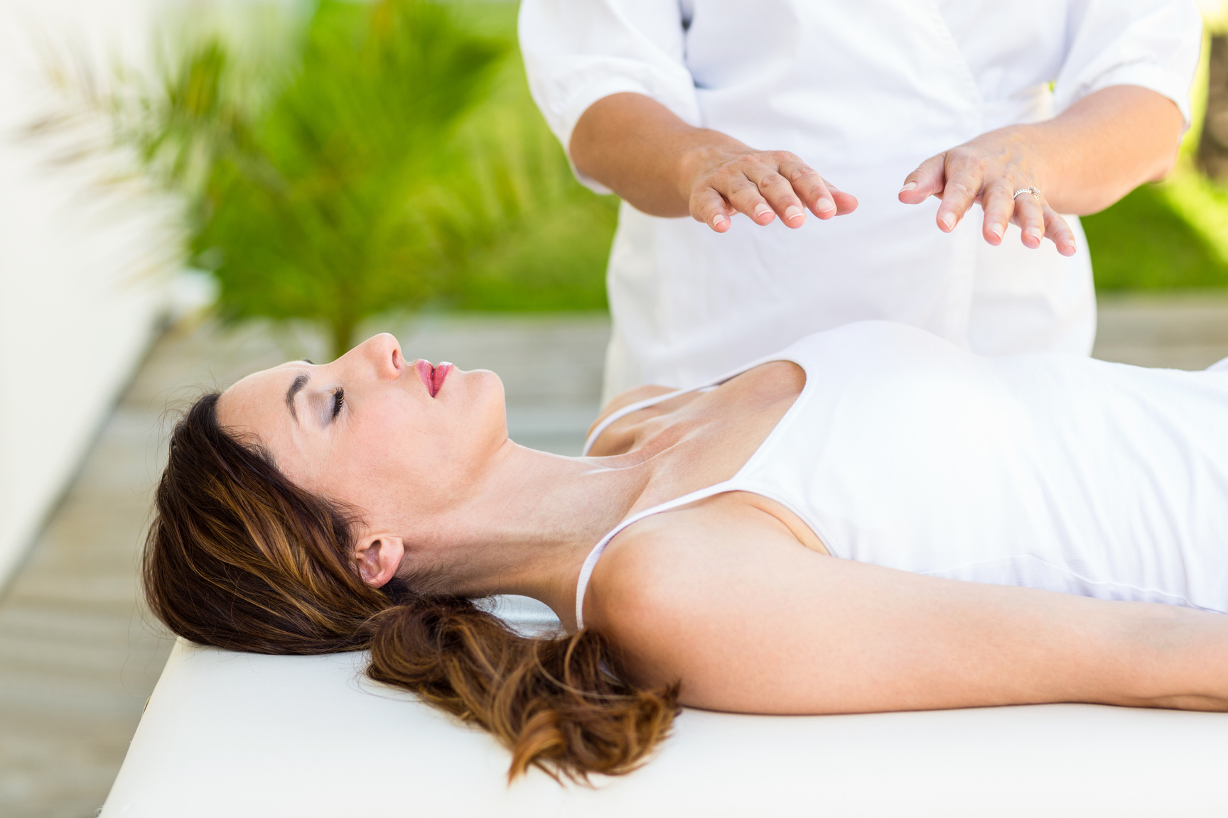 Calm woman receiving reiki treatment
